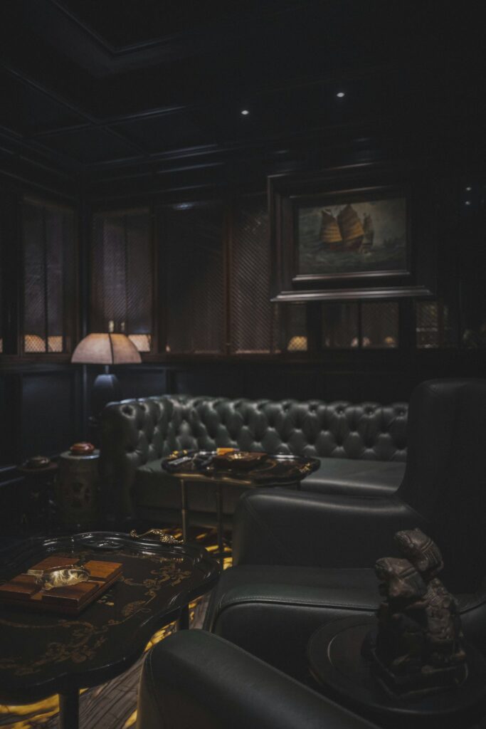 A dark panelled members' lounge with leather chairs